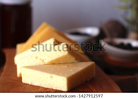 jars of cut cheeses and honey  Royalty-Free Stock Photo #1427912597