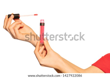 Woman's hands with liquid lipstick and applicator Royalty-Free Stock Photo #1427922086