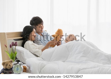 Asian teenagers being together happily on the bed, concept for love, spending time together and the lifestyle of modern young people.
