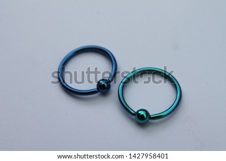 Anodized titanium 1.6mm x 14mm captive ball ring (CBR) body jewellery Royalty-Free Stock Photo #1427958401