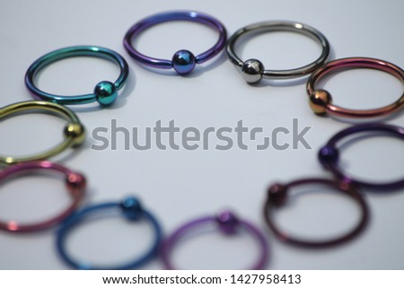Anodized titanium 1.6mm x 14mm captive ball ring (CBR) body jewellery Royalty-Free Stock Photo #1427958413