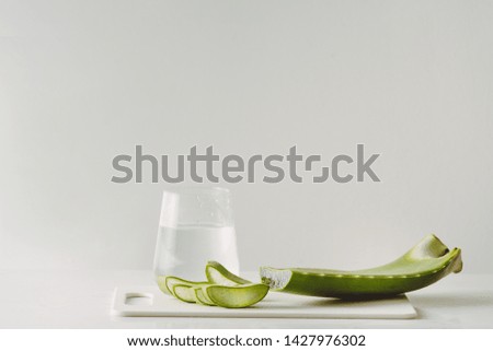 Fresh aloe vera leaves and glass of aloe vera juice healthy drink isolated on white background
