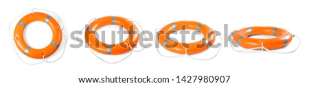 Set of orange lifebuoy rings on white background  Royalty-Free Stock Photo #1427980907