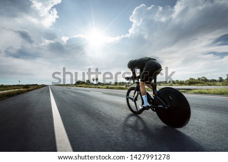 Asian men are cycling "time trial bike" in the morning Royalty-Free Stock Photo #1427991278