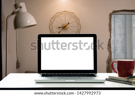Workspace white desk with Mockup Blank screen laptop,Interior home blurred background. - Image