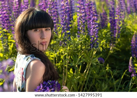 Young beautiful girl among the flower meadow. Beauty, nature.