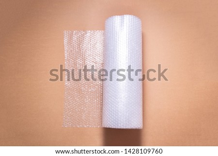 Roll of bubble film on Cardboard background