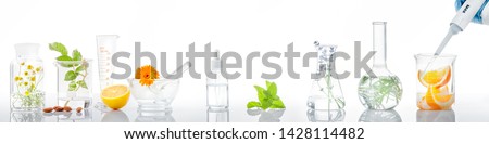 Scientific Experiment.Herbs,flower and orange  in test tubes Royalty-Free Stock Photo #1428114482