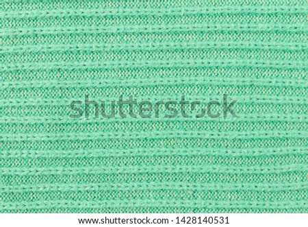 Green Knitting Texture or Knitted Texture Background in macro style. Knitting Texture or Knitted Texture in vintage style for design