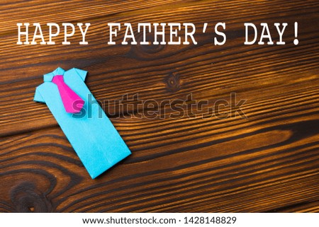 Happy fathers day sign on paper shirts  laid on wooden floor backround. - Image 