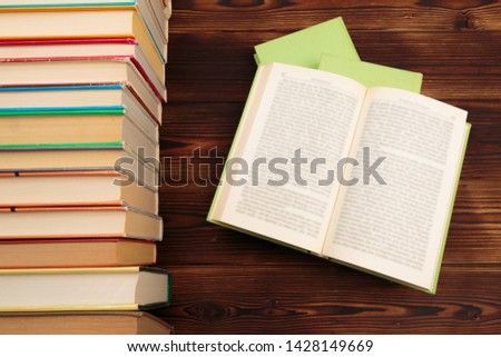  learning concept with opening book or textbook in old library, stack piles of literature text academic archive on reading desk and aisle of bookshelves in school study class room background - Image