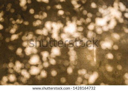 Silhouette black of Circle-bokeh with brown background,sunlight rays through wall concrete
