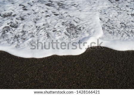 Waves and bubbles on the beach