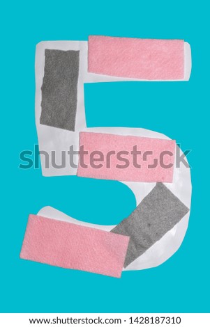 the number 5 symbol , with pink and gray felt strips, on a blue 