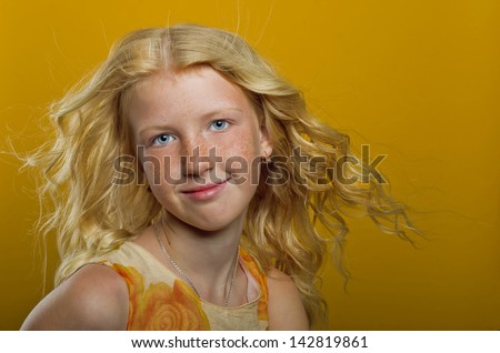 Beautiful blonde girl on a yellow background