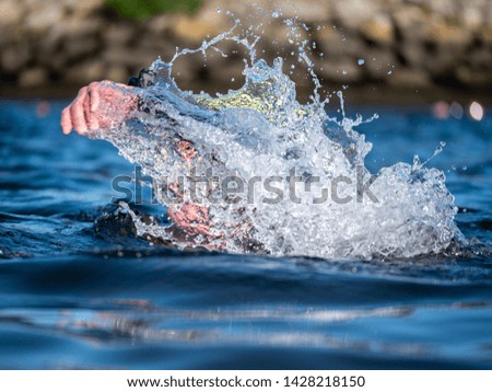 Triathlete swimming on a river in Pontevedra