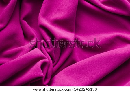 Background texture of purple fleece, soft napped insulating fabric made of polyester, wavy pattern, top view