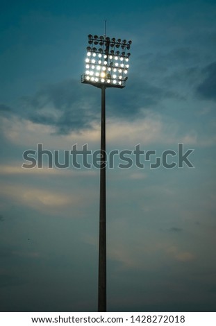 super wide shot of partially lite lightbulbs in a stadium