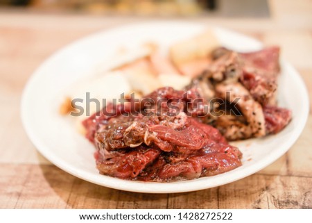 A soft selected focus picture of the Korean Barbecue meat and chicken. Marinated with Korean spicy sauce. High tone picture with warm effect.