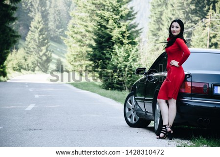 Red dress, black car and open road