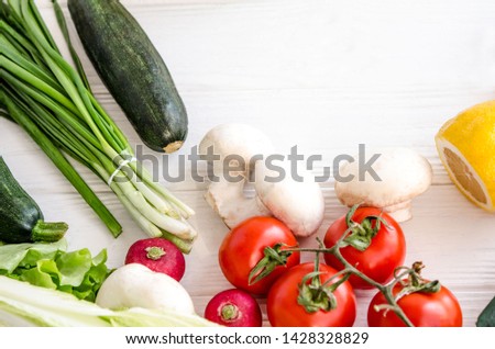 eco-vegan fresh vegetables and fruits of various kinds on a white wooden table close-up
