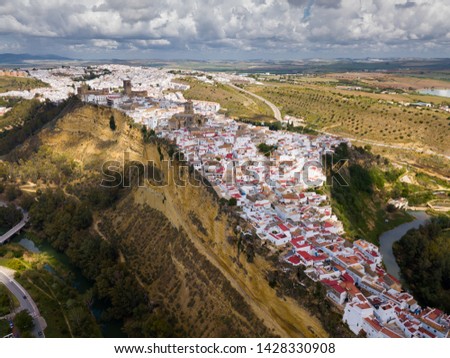 Aerial view of ancient city of Arcos de la Frontera located on edge of cliff on bank of Guadalete river, Andalusia, Spain

