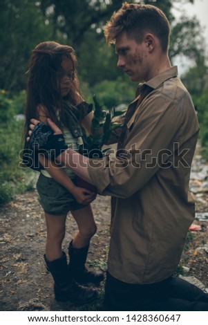 Homeless father and daughter are in garbage dump. The concept of environmental pollution, poverty and homelessness.