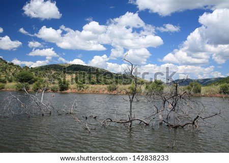 pilanesberg natural reserve park of extinct volcanoes within lunar landscape with lakes and savannah fauna clouds garden