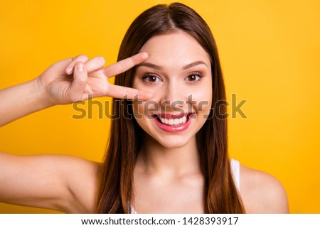 Close up photo of lovely charming teen teenager good-looking she her make v-sign feel rejoice candid dressed white fashionable clothing isolated yellow background