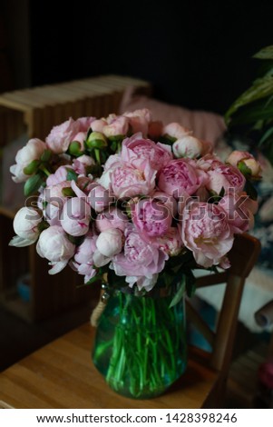 peonies roses tulips bouquet of flowers on a leg in the interior of the restaurant at the celebration shop floristry wedding salon