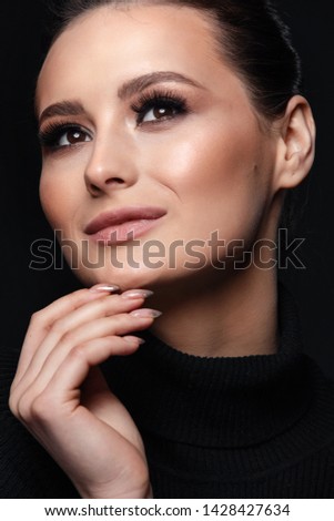 Beauty Cosmetics.Woman applying black mascara on eyelashes with makeup brush. photos of appealing brunette girl on black background.High Resolution
