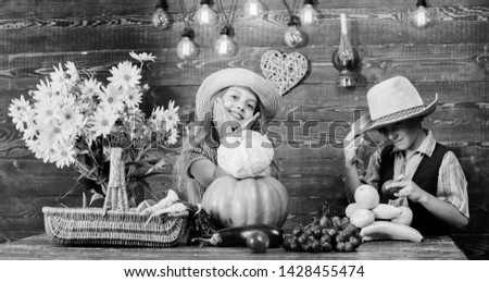 Kids girl boy wear hat celebrate harvest festival rustic style. Celebrate fall traditions. Elementary school fall festival idea. Autumn harvest festival. Children play vegetables pumpkin cabbage.
