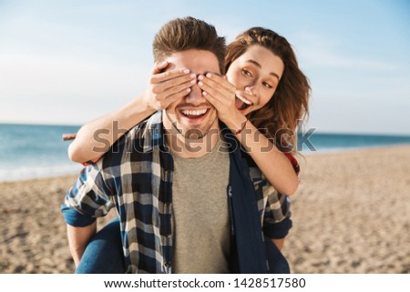 Photo of happy young loving couple outside in free alternative vacation camping hugging.