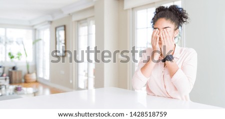 Wide angle of beautiful african american woman with afro hair rubbing eyes for fatigue and headache, sleepy and tired expression. Vision problem
