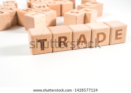 word TRADE on wood cube dices on white background.