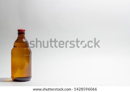 Beer bottle with a red cork on a gray background. Design. Minimalism. Creative idea. Mock-up