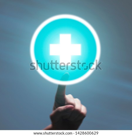 Hospital concept. Woman hand touching blue plus button on grey background