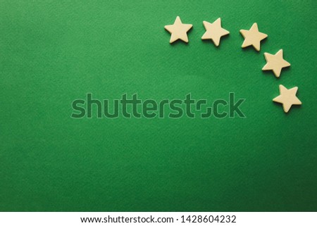 five white stars on a green background