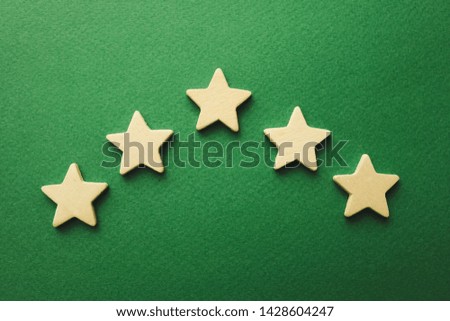 five white stars on a green background