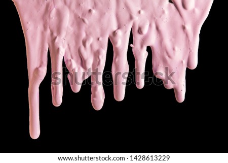 pink paint flows over the black surface