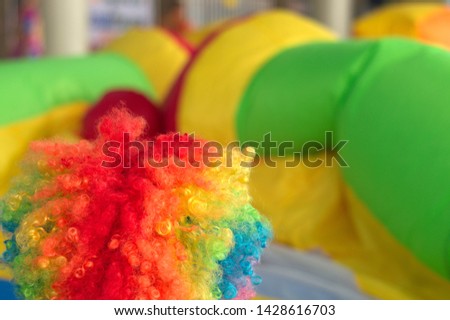 Multi Color Joker Wig on bounce house castle with hoop Inflatable bouncer colorful background
