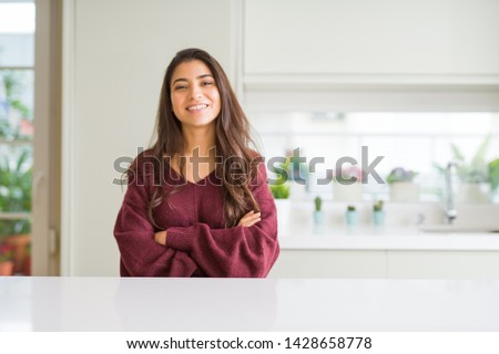 Young beautiful woman at home happy face smiling with crossed arms looking at the camera. Positive person. Royalty-Free Stock Photo #1428658778