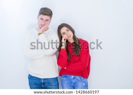 Beautiful young couple over white isolated background thinking looking tired and bored with depression problems with crossed arms.
