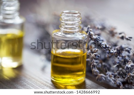 Lavender oil bottles with lavender flowers closup, lavender flowers essential oil, aromatherapy and spa setting