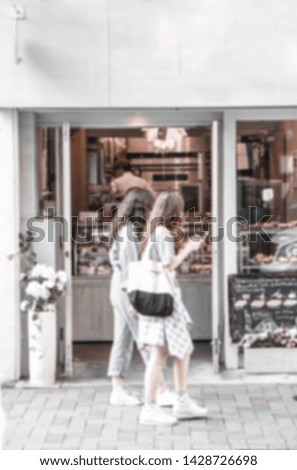 A picture of a person walking through the area, a cafe in Tokyo. Blurred images represent movement. And in brown tones.