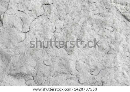 The texture of natural white granite stone with cracks. Background of natural stone gray. Texture with fine flaw.
