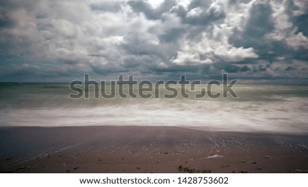 Dramatic sky with large clouds over the beach 