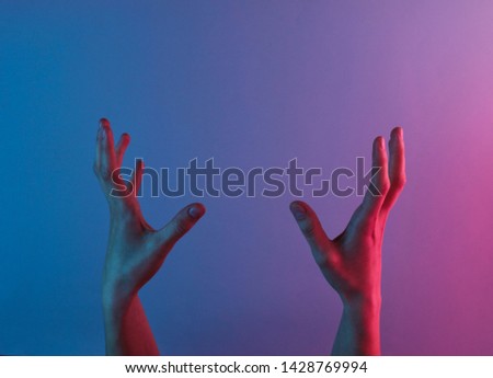 Awesome female hands with blue neon red light. Halloween theme. Minimalism fashion. Surrealism. Concept art