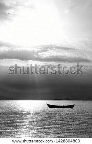 Sunset in the sea with a boat. A picture of a small boat with a beautiful sunset background.