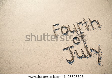 Fourth of July message written for the American Independence Day holiday in smooth sand on the beach